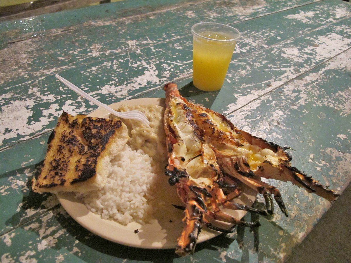 crack-open-a-fresh-grilled-lobster-right-on-the-beach-in-caye-caulker-belize