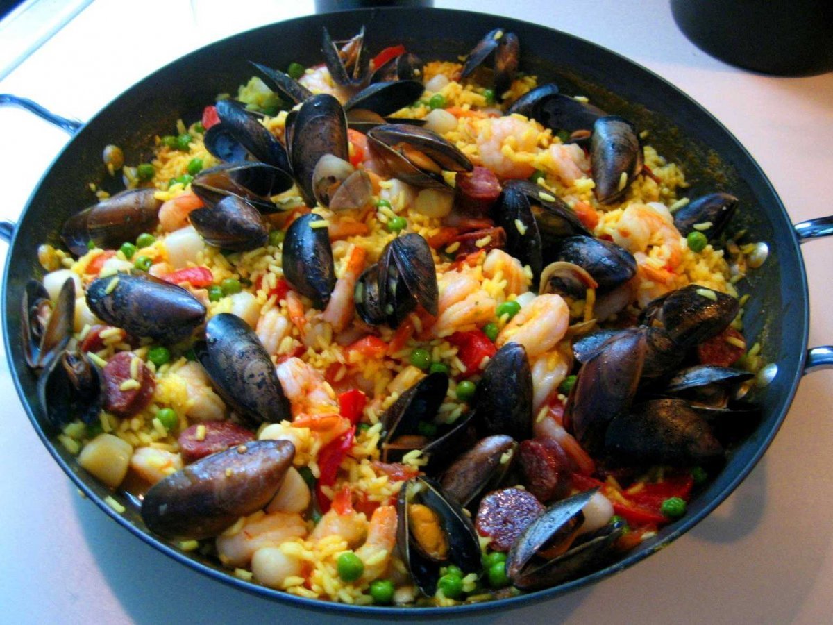 share-a-pot-of-paella-saffron-infused-rice-with-seafood-and-chorizo-with-friends-at-famed-can-maj-a-restaurant-on-the-beach-in-barcelona-spain