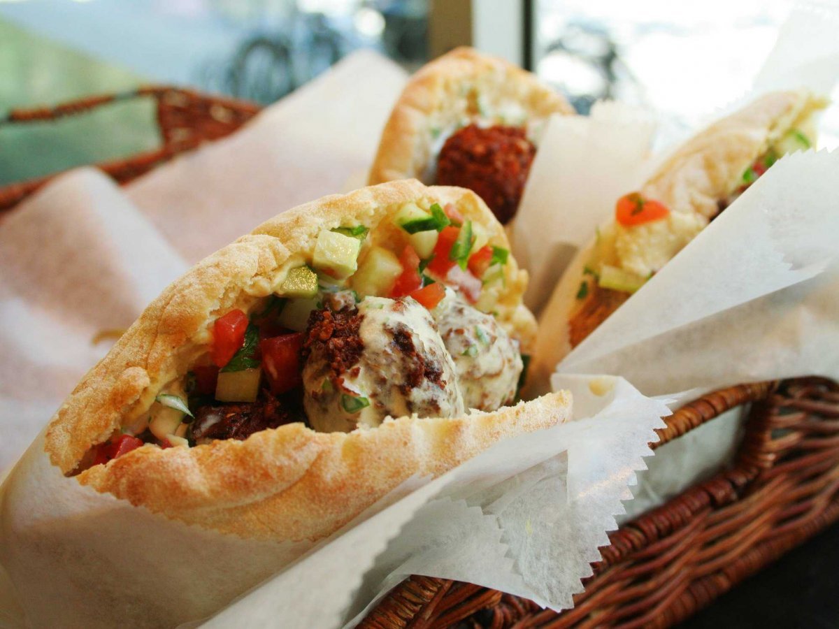 take-a-bite-out-of-a-crispy-chewy-fresh-falafel-sandwich-overstuffed-with-vegetables-in-amman-jordan-falafel-al-quds-and-abu-staif-are-famous-falafel-shops