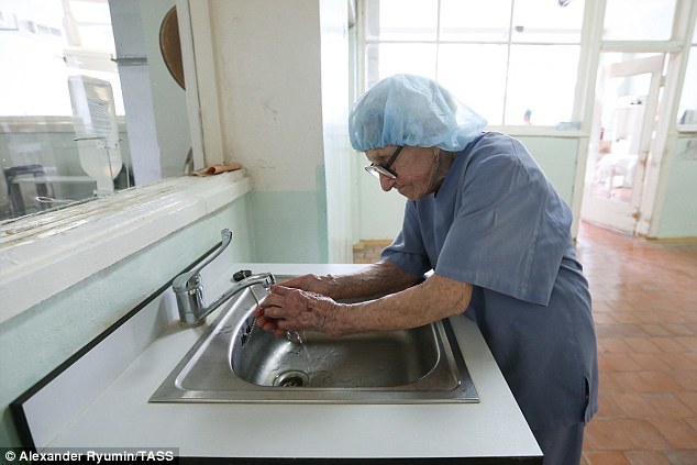 3CB99D7B00000578 4180646 The experienced physician scrubs up in a hair net before going i a 4 1485967232791